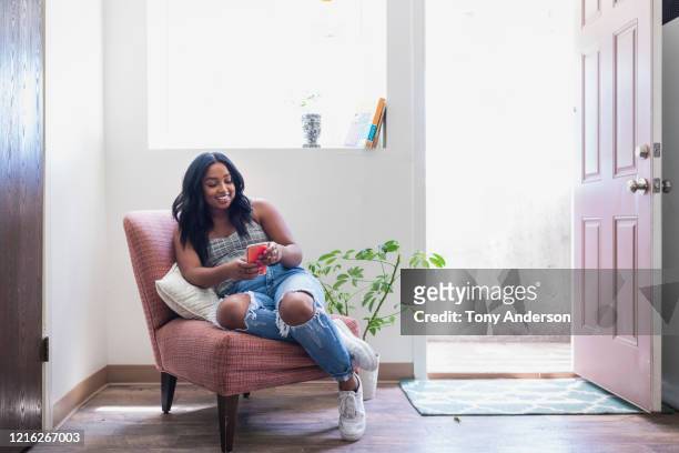 Young woman looking at her phone indoors