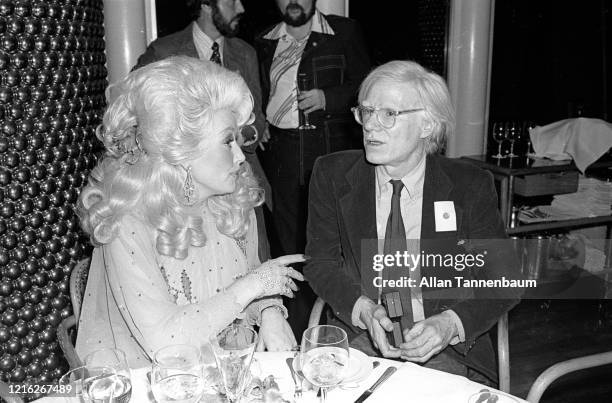 American Country musician Dolly Parton and Pop artist Andy Warhol together at the Windows on the World restaurant, New York, New York, May 14, 1977....