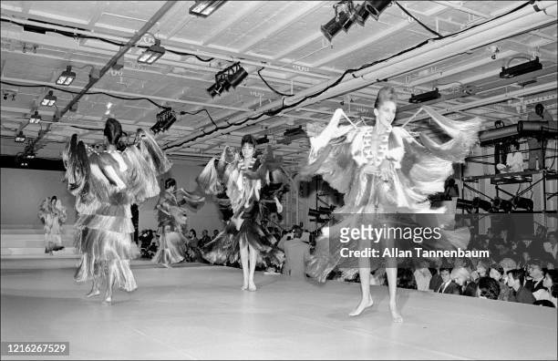 View of unidentified models on the catwalk during Issey Miyake's Spring fashion collection show, held at the Intrepid Sea, Air, and Space Museum, New...