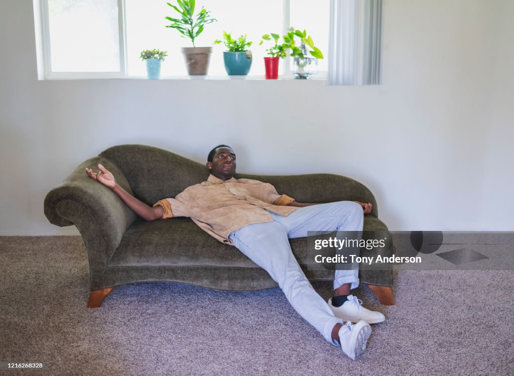 Young man lounging on sofa