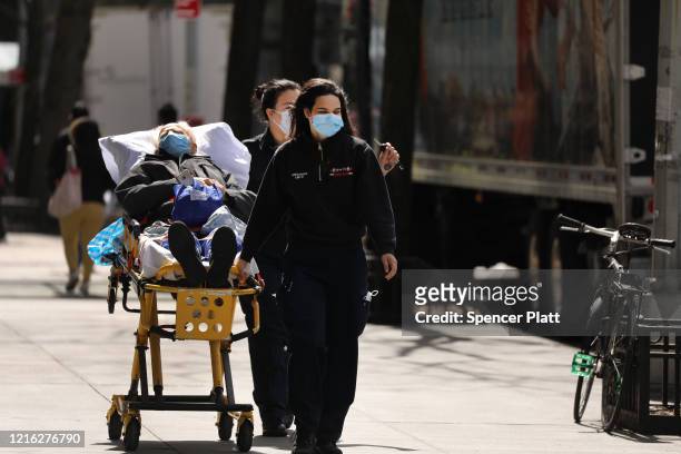Medical workers handle a patient at Mount Sinai Hospital amid the coronavirus pandemic on April 01, 2020 in New York City. Hospitals in New York...