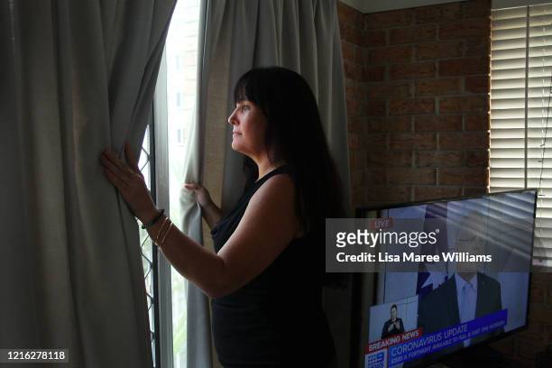 Carlene O'Loughlin looks out the window from her home on March 30, 2020 on the Sunshine Coast, Australia. Carlene a single mother of two has recently...