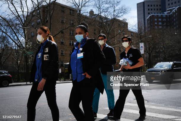 Medical workers walk outside of Mount Sinai Hospital amid the coronavirus pandemic on April 01, 2020 in New York City. Hospitals in New York City,...