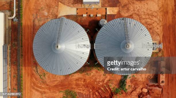 aerial overhead shot of farm barn and silos - angola drone stock pictures, royalty-free photos & images