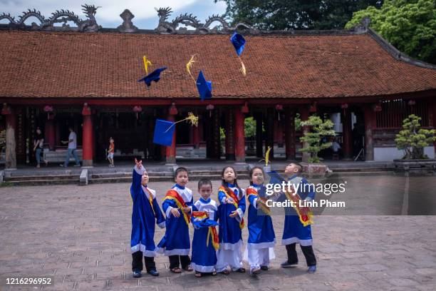 Pupils have their kindergarten graduation photo taken at Temple of Literature, a popular destination amongst both locals and tourists, on May 31,...