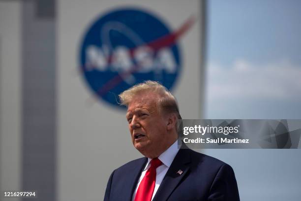 President Donald Trump talks on the rooftop of the Operational Building at NASA after the launch of the SpaceX Falcon 9 rocket with NASA astronauts...