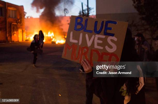 Minnesota MAY 29, 2020A protester holds a sign that says Blue Lives Murder on Friday night, May 29, 2020. Protesting continues for a third day in...