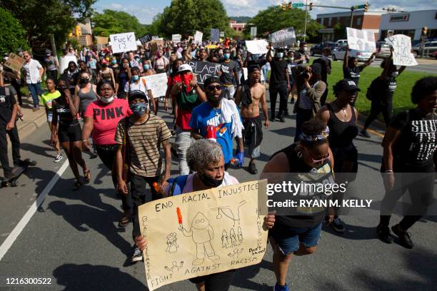 People march during a racial justice protest in Charlottesville on May 30, 2020. - Demonstrations are being held across the US after George Floyd...