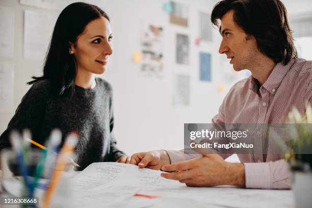 coworkers talking together in design studio office - face to face interview stock pictures, royalty-free photos & images