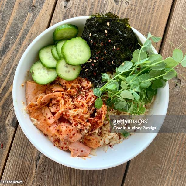 salmon brown rice bowl - rice bowl stock pictures, royalty-free photos & images