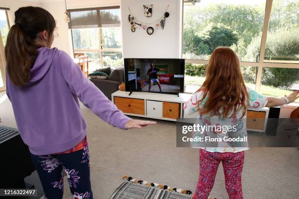 Sisters Nina Goodall and Ivy Goodall, who are related to the photographer, follow a Zumba lesson online at their home in Kaipara Flats on April 02,...