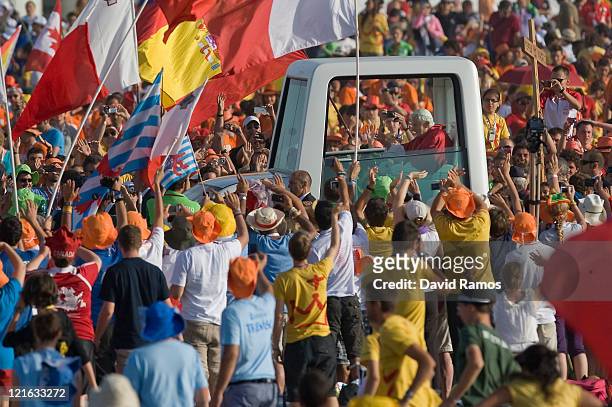 Pope Benedict XVI waves to the crowd on his arrival at the Cuatro Vientos Airport for the closing ceremony of the World Youth Day 2011 on August 21,...