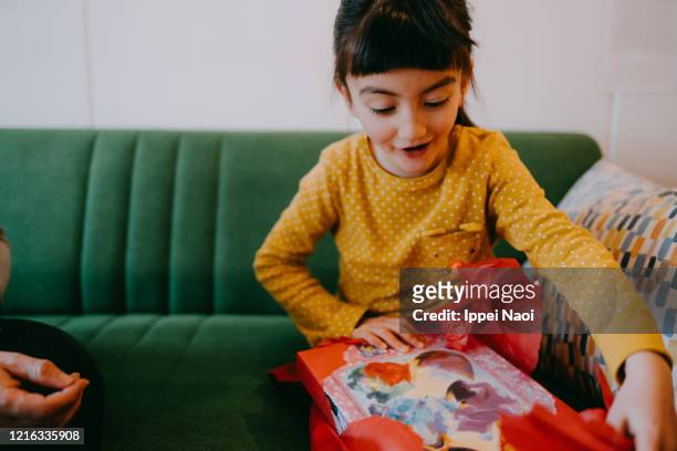 cute young girl excited with birthday present - gift ストックフォトと画像