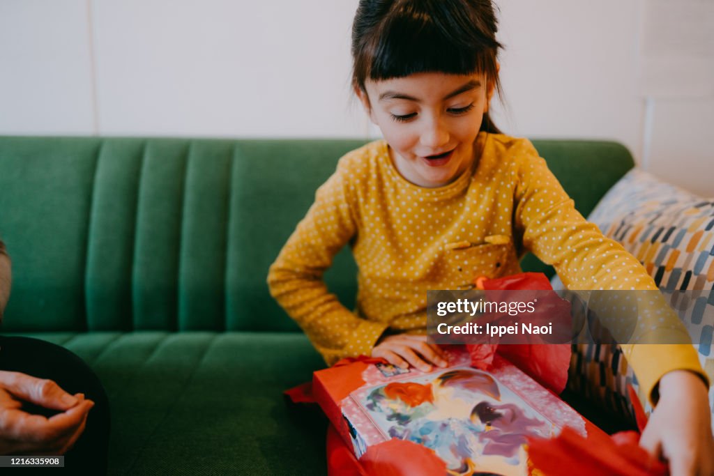 Cute young girl excited with birthday present