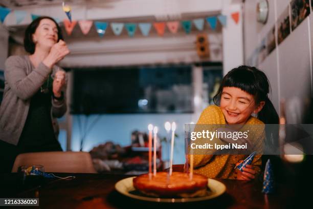 young girl surprised with party popper at her birthday party - surprise birthday party stock pictures, royalty-free photos & images