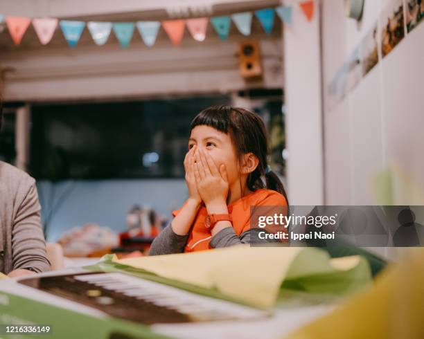 cute young girl surprised and excited with birthday present - surprise gift foto e immagini stock