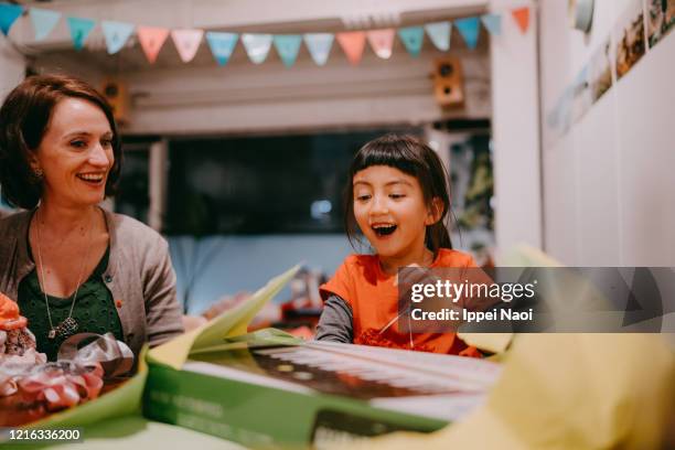 cute young girl excited with birthday present - birthday gift stock pictures, royalty-free photos & images
