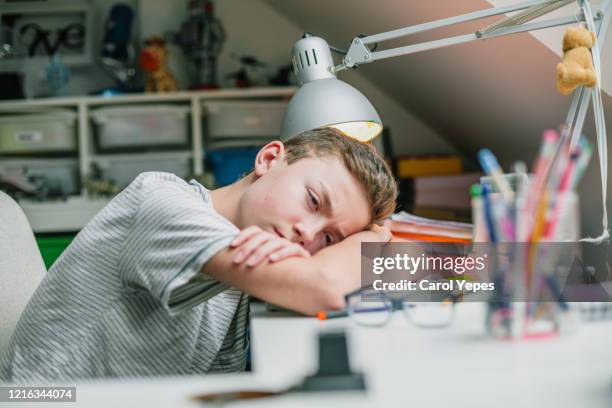 stressed student during home schooling pandemic alert - teenager learning child to read stock pictures, royalty-free photos & images