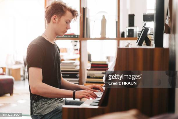 tiener die piano thuis speelt - keyboard white stockfoto's en -beelden
