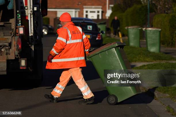 Refuse collector from Redcar and Cleveland Council works to empty bins in the streets of Saltburn as the UK adjusts to life under the Coronavirus...