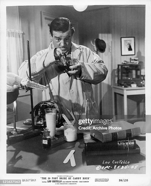 Lou Costello mixes chemicals in a scene from the film 'The 30 Foot Bride Of Candy Rock', 1959.