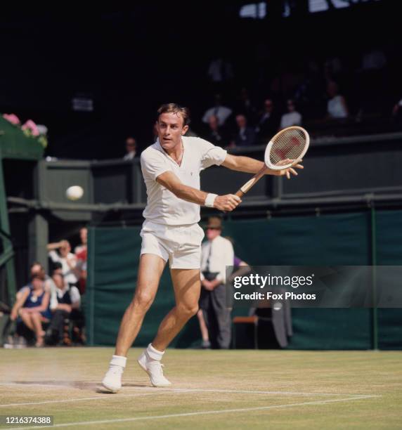 John Newcombe of Australia makes a backhand return against Arthur Ashe during their Men's Singles fourth round match at the Wimbledon Lawn Tennis...