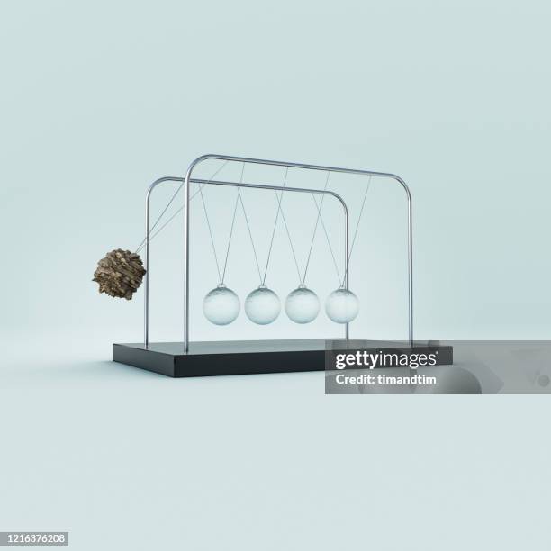 newton's cradle made of glass and stone - newtons cradle stock pictures, royalty-free photos & images