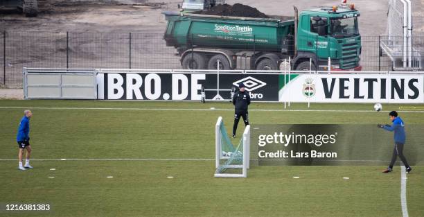 Weston McKennie kicks the ball next to Amine Harit during a training session at FC Schalke 04 training ground on April 02, 2020 in Gelsenkirchen,...