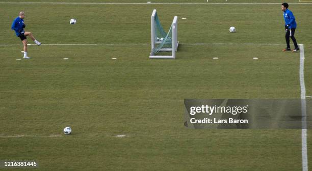 Amine Harit kciks the ball next to Weston McKennie during a training session at FC Schalke 04 training ground on April 02, 2020 in Gelsenkirchen,...