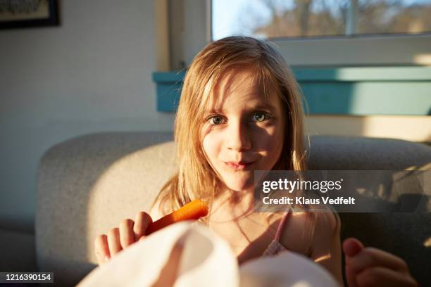 portrait smiling girl on sunny sofa - copenhagen food stock pictures, royalty-free photos & images