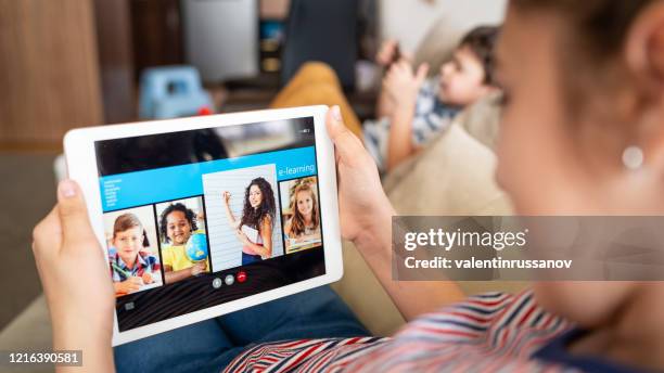 homeschooling and distance learning teenage girl studying with video online lesson at home - watching youtube stock pictures, royalty-free photos & images