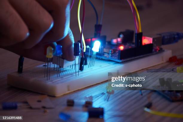 an engineer working on open-source hardware and software project, breadboard, electronic module - resistor stock pictures, royalty-free photos & images