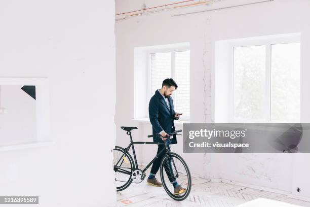 man checking his smartphone while going to work - minimalist living in japan stock pictures, royalty-free photos & images