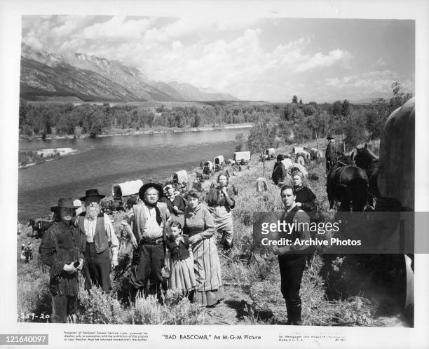 Wallace Beery, Margaret O'Brien, Marjorie Main standing in a group by the river in a scene from the film 'Bad Bascomb', 1946.