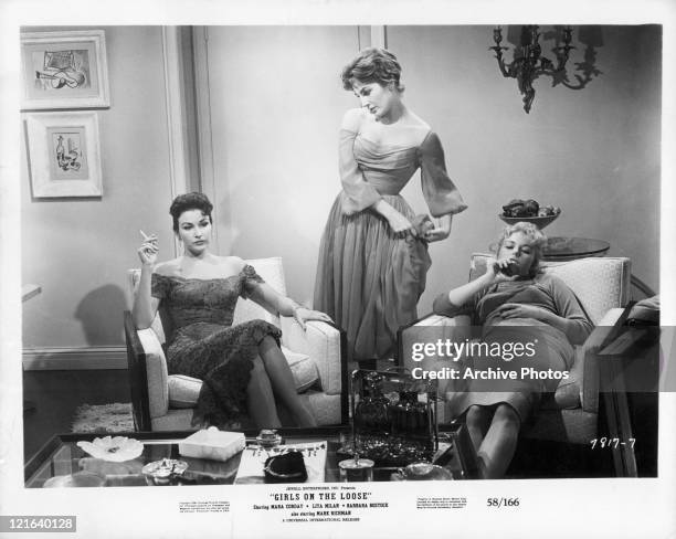 Mara Corday, Lita Milan and unidentified actress sitting in room having conversation in a scene from the film 'Girls On The Loose', 1958.