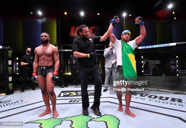 In this handout provided by UFC, Gilbert Burns of Brazil reacts after his victory over Tyron Woodley in their welterweight fight during the UFC Fight...