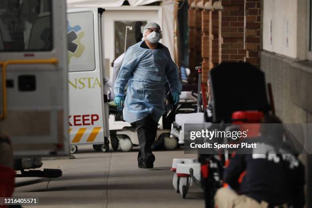 Medical workers bring in patients at a special coronavirus intake tent at Maimonides Medical Center in Borough Park section of Brooklyn which has...