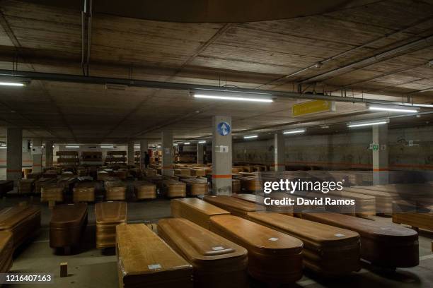 Coffins containing the bodies of people who have died of coronavirus are lined up in the long-term parking of the Collserola morgue before they...