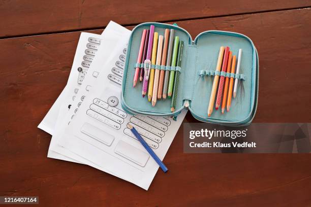 colored pencils and homework on table - math homework stock pictures, royalty-free photos & images