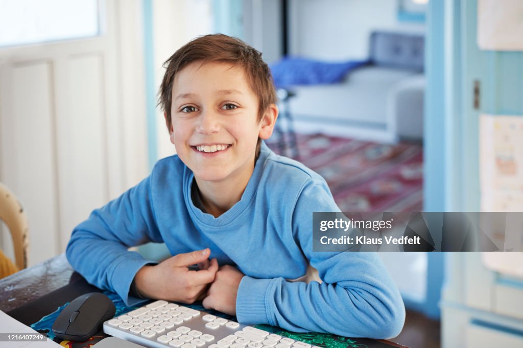 Good Boy Using A Computer Portrait Smiling Boy Using Computer At Table High-Res Stock Photo ...