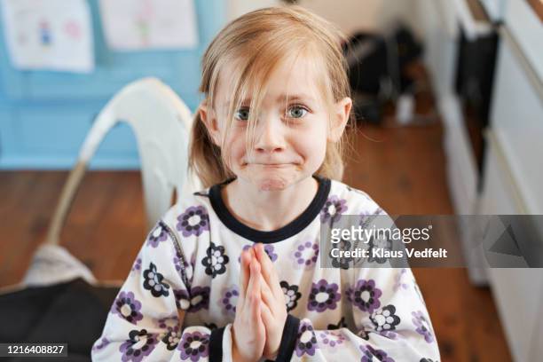 portrait cute girl pleading with hands clasped - förödmjukelse bildbanksfoton och bilder