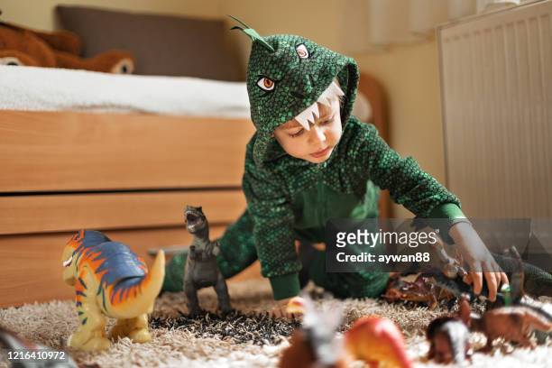 adorable boy playing with his dinosaurs - dinossauro imagens e fotografias de stock