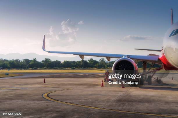 the plane stands with the tunnel at the airport terminal building of the city business center. - aircraft refuelling stock pictures, royalty-free photos & images