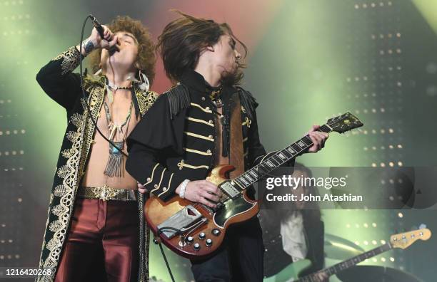 Brothers Josh and Jake Kiszka are shown performing together on stage during a "live" concert appearance with Greta Van Fleet on May 24, 2019.