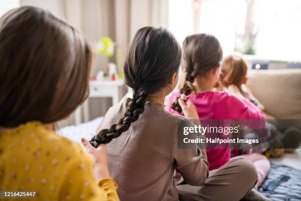 group of small girl friends sitting on bed, braiding hair. - endast flickor bildbanksfoton och bilder