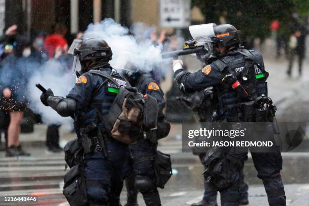 Washington State Police uses tear gas to disperse a crowd during a demonstration protesting the death of George Floyd, a black man who died May 25 in...