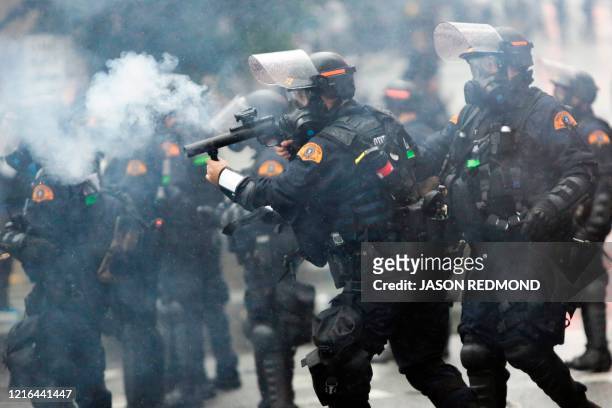 Washington State Police uses tear gas to disperse a crowd during a demonstration protesting the death of George Floyd, a black man who died May 25 in...