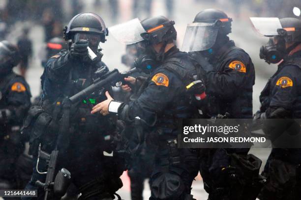 Washington State Police uses tear gas to disperse a crowd during a demonstration protesting the death of George Floyd, a black man who died May 25 in...
