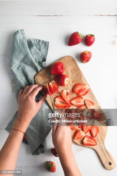 strawberries on cutting board, with knife and plate - cutting stock pictures, royalty-free photos & images