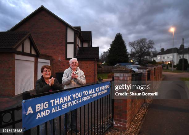 Residents in Abington Vale applaud NHS staff and other key workers from their home on April 02, 2020 in Northampton, United Kingdom. Members of the...